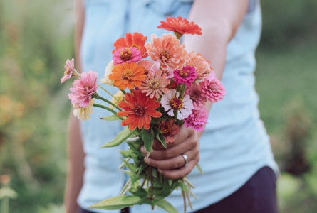 image of woman holding out a bouquet